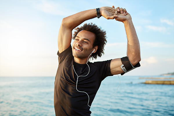 Man stretching and working out at the beach