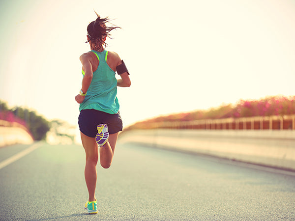 Woman running, exercising on road outside, daylight