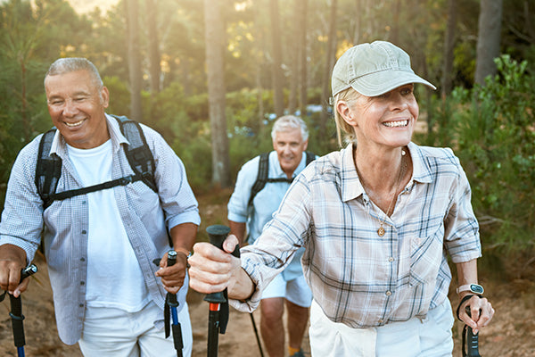 Senior group outdoors, hiking in forest