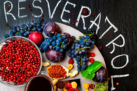 Assortment of berries, fruit, grapes on table that contain Resveratrol