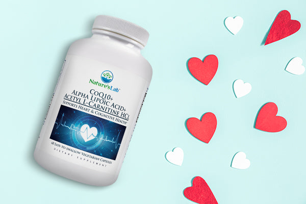 Nature's Lab CoQ10 product on blue background with heart shape paper cutouts, heart health concept