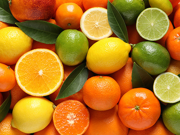 assortment of lemons, limes and oranges, closeup which contain bioflavonoids like quercetin