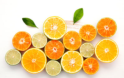 Flat lay of sliced oranges, lemon, citrus